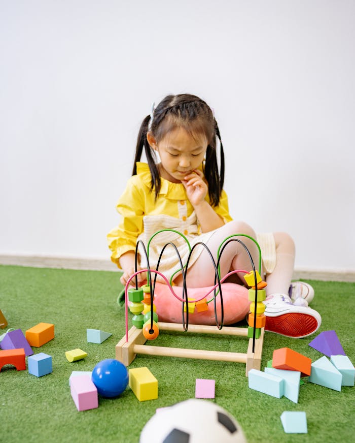 A young girl plays with educational toys, stimulating learning and creativity indoors.